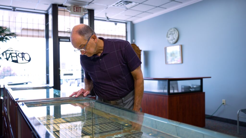 Main looking at jewelry case